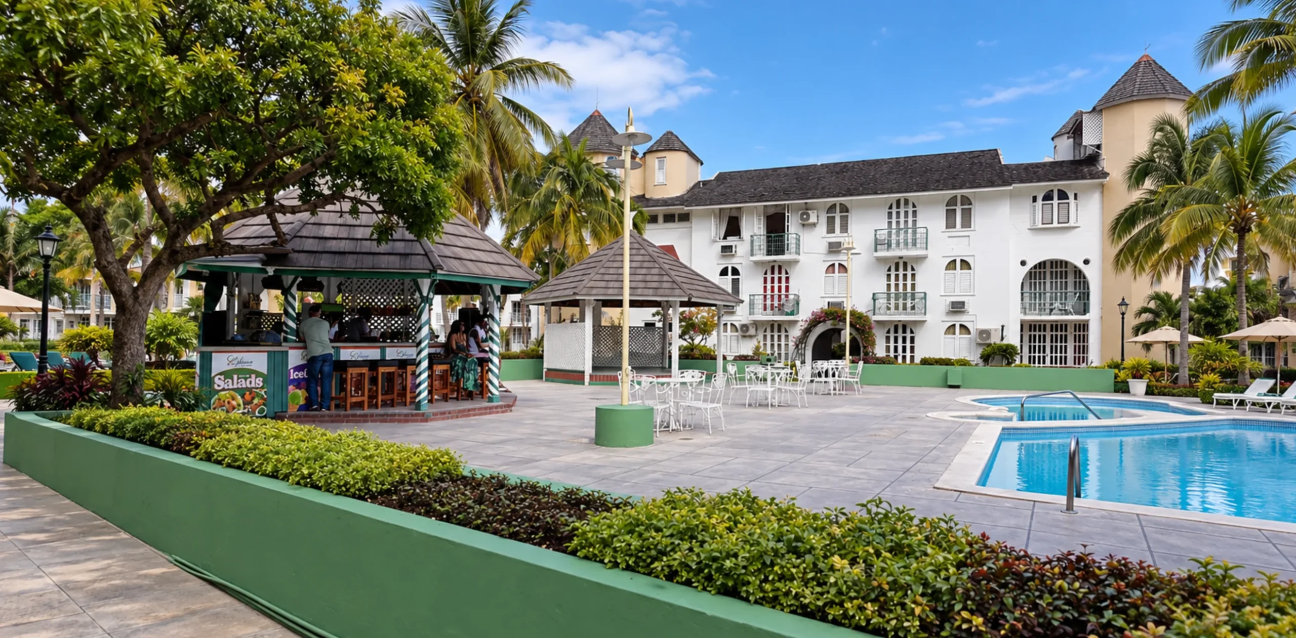 Exterior view of Almond Grove at Sand Castle resort grounds and oceanfront suites in Ocho Rios Jamaica