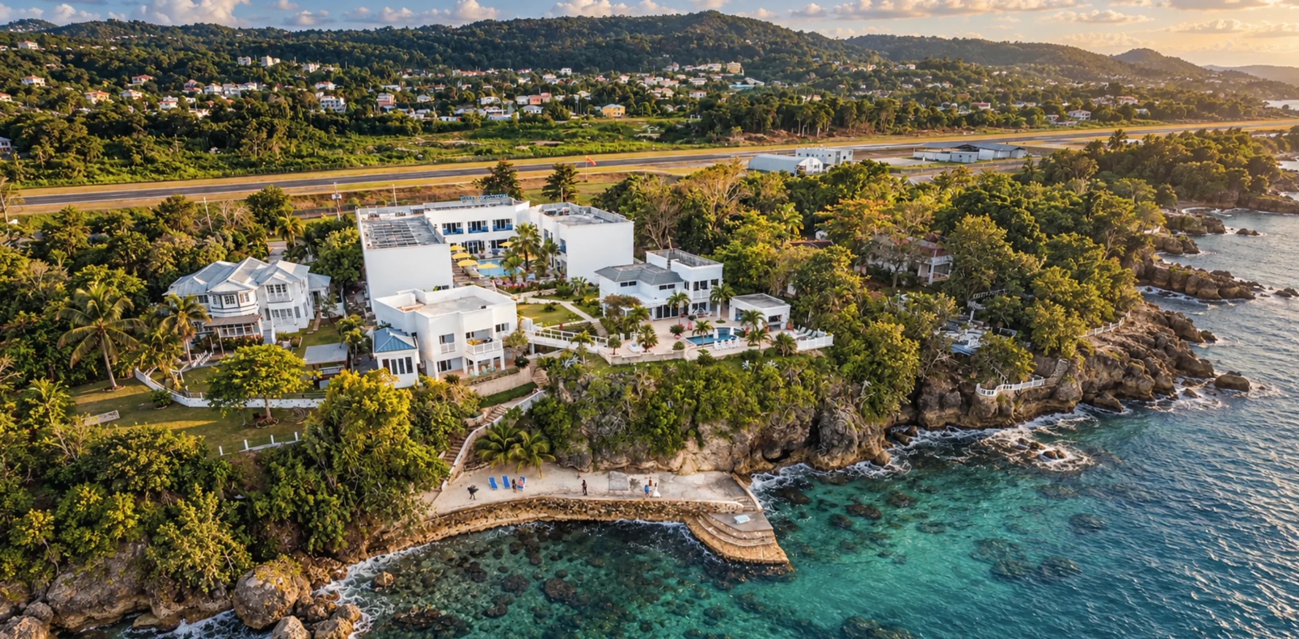 Cliffside luxury villa estate architecture surrounded by manicured tropical gardens and oceanfront scenery in Jamaica.