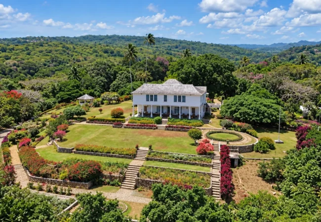 Oceanfront view of historic stone villa architecture along a private mile of Caribbean sea coastline in Jamaica.