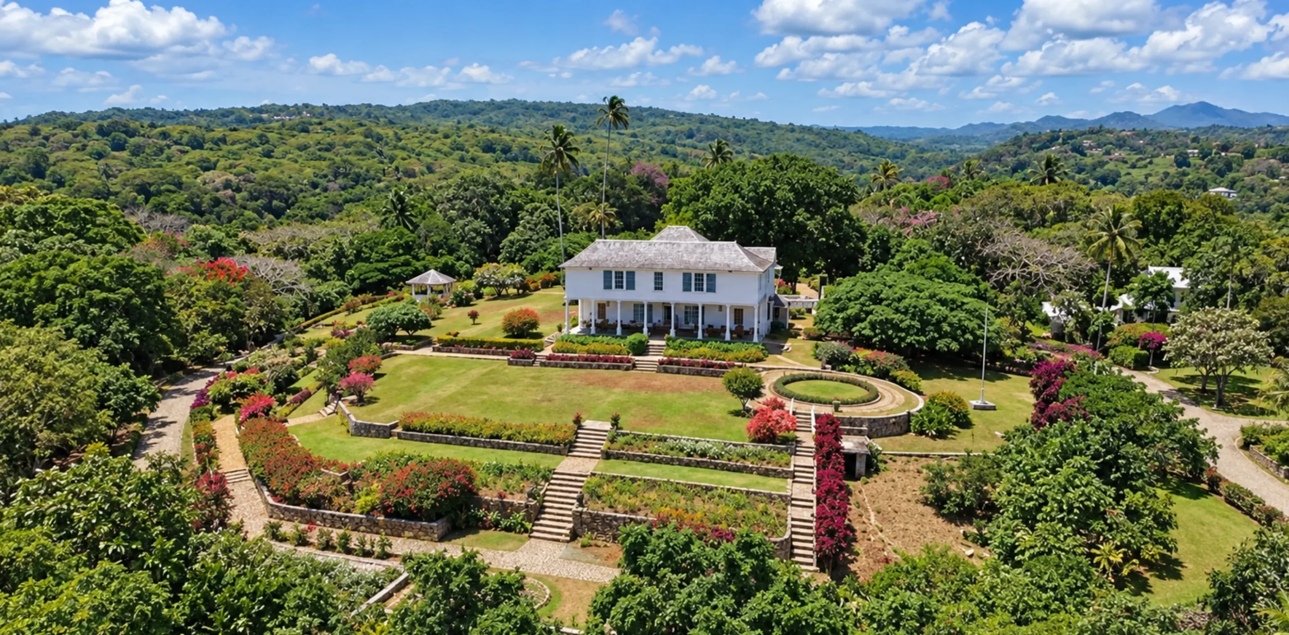 Oceanfront view of historic stone villa architecture along a private mile of Caribbean sea coastline in Jamaica.